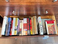 Drawer containing row of assorted book spines