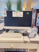 Front view of HP all-in-one computer with keyboard, mice and headset