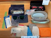 Lot overview showing all eyewear, cases, repair kit and cleaning cloths