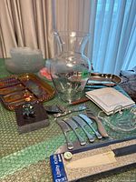 Group view showing vase, knives, trays, plates, bowls, figurine