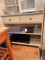 Front view of kitchen cart showing drawers, shelves, laminate top