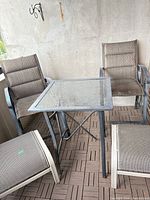 Full view of table with two chairs and ottoman