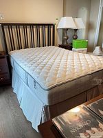 Full mattress on box spring with headboard and frame visible
