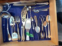 All 23 utensils arranged in drawer