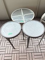 Top view of all three round glass-top tables