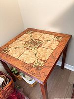 Full view of table showing tile top and wooden frame