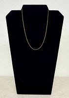 Full view of yellow gold chain on display form