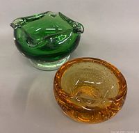 Green and amber controlled-bubble glass bowls overview
