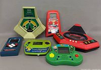 Group shot of the six vintage handheld electronic games
