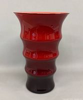 Full front view of red ribbed Holmegaard vase