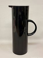 Full side view of black Stelton EM77 jug showing handle and spout