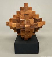 Front view of wooden ladder puzzle on base