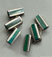 Front view showing turquoise inlay and silver frames of both earrings
