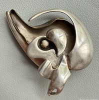 Front view showing abstract design and patina