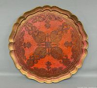 Front view of round orange and gilt Florentine tray