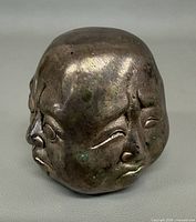 Angled view showing two faces and patina