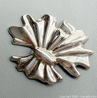Front view of polished sterling silver brooch