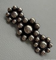 Front view of sterling silver floral brooch