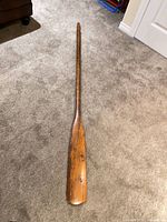 Full length view of wooden oar, showing overall condition