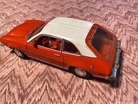 Three-quarter top view showing orange body, white roof, interior detail