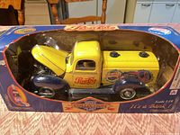 Front view of boxed yellow/blue Pepsi-Cola die-cast truck with hood open