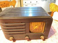 Front view showing Bakelite cabinet, speaker grille, dial and knobs