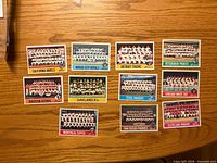 Fronts of eleven 1976 Topps team photo cards laid out