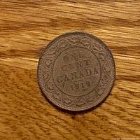 Reverse showing ONE CENT CANADA 1919 legend and vine border