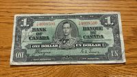 Obverse of 1937 $1 note showing serial number, portrait, signatures