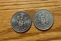 Reverse sides of 1980 and 1981 50 cent coins showing dates and coat of arms