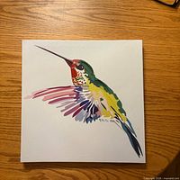 Front view of square canvas showing multicolour hummingbird design