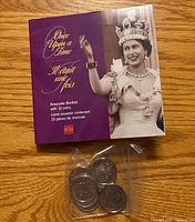 Booklet cover and plastic bag containing coins