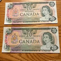Fronts of both 1979 Canada $20 bills showing portrait and denomination