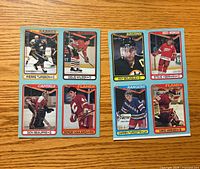 Fronts of both uncut panels showing eight player cards