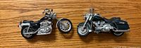 Both die-cast motorcycles side by side on table