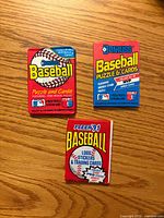 Front view of three sealed baseball card packs: two Donruss Puzzle & Cards, one Fleer ’91