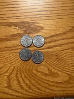Obverse and reverse of four 1945 Victory nickels