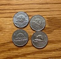 Reverse view of four Canadian 5-cent coins, beaver design visible