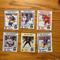 Fronts of six Kraft NHL cards laid out on wood surface