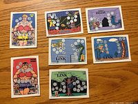 Fronts of six cards showing artwork and scratch areas