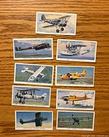 Fronts of nine 1938 Player's Cigarettes RAF aircraft cards laid out on table