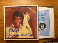 Front of Elvis! His Greatest Hits box with booklet visible inside
