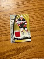 Front of card showing player image, jersey swatch, serial number
