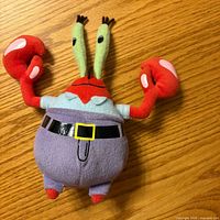 Front view of Mr. Krabs plush showing colours, belt, eyes, overall condition