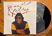 Front jacket with artist image, title and price sticker, record partially visible in inner sleeve