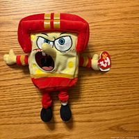 Front view of Ty SpongeBob QB plush showing helmet, uniform, and Ty tag