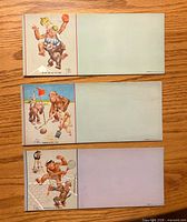 Fronts of three sports-themed ink blotters showing cartoons and blank blotting areas