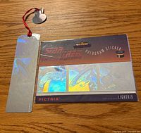 Front view of sealed hologram sticker package and holographic bookmark