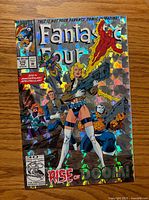 Front cover showing holographic foil artwork, issue number, prices, anniversary text
