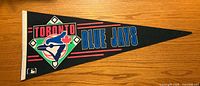 Front view of black felt pennant showing full graphics